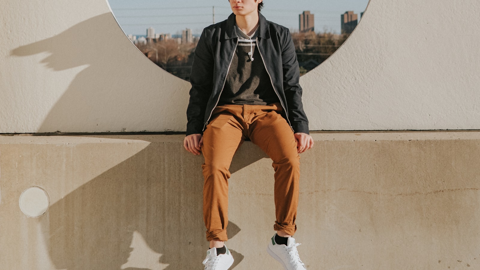 A relaxed portrait of a person near a window, lit by soft daylight