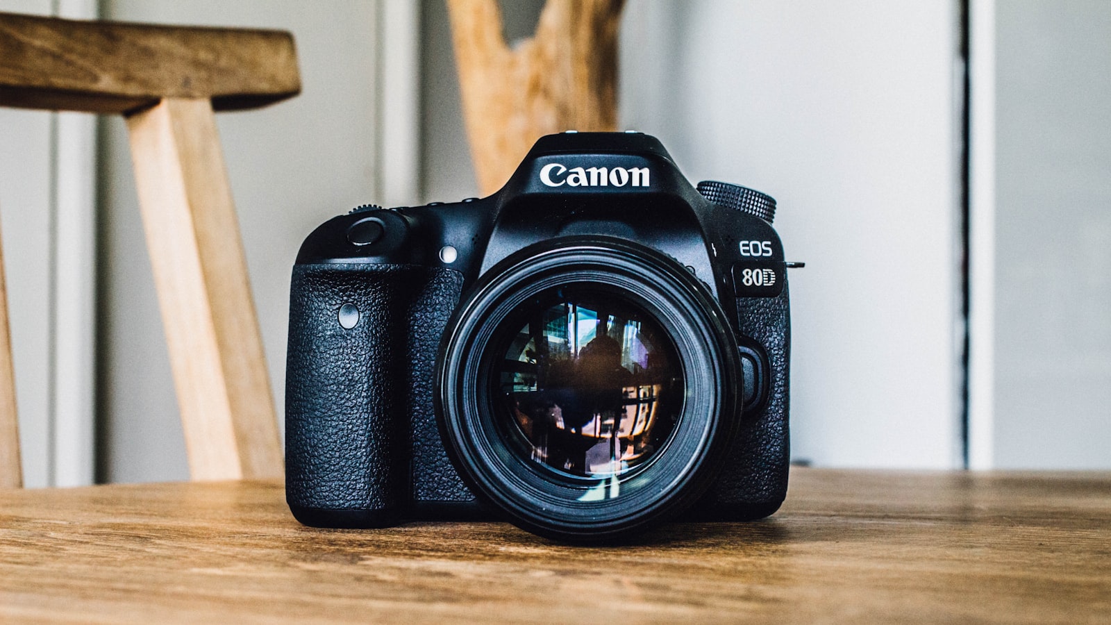 A camera lens seen from the front with its aperture blades forming a small hexagonal opening.